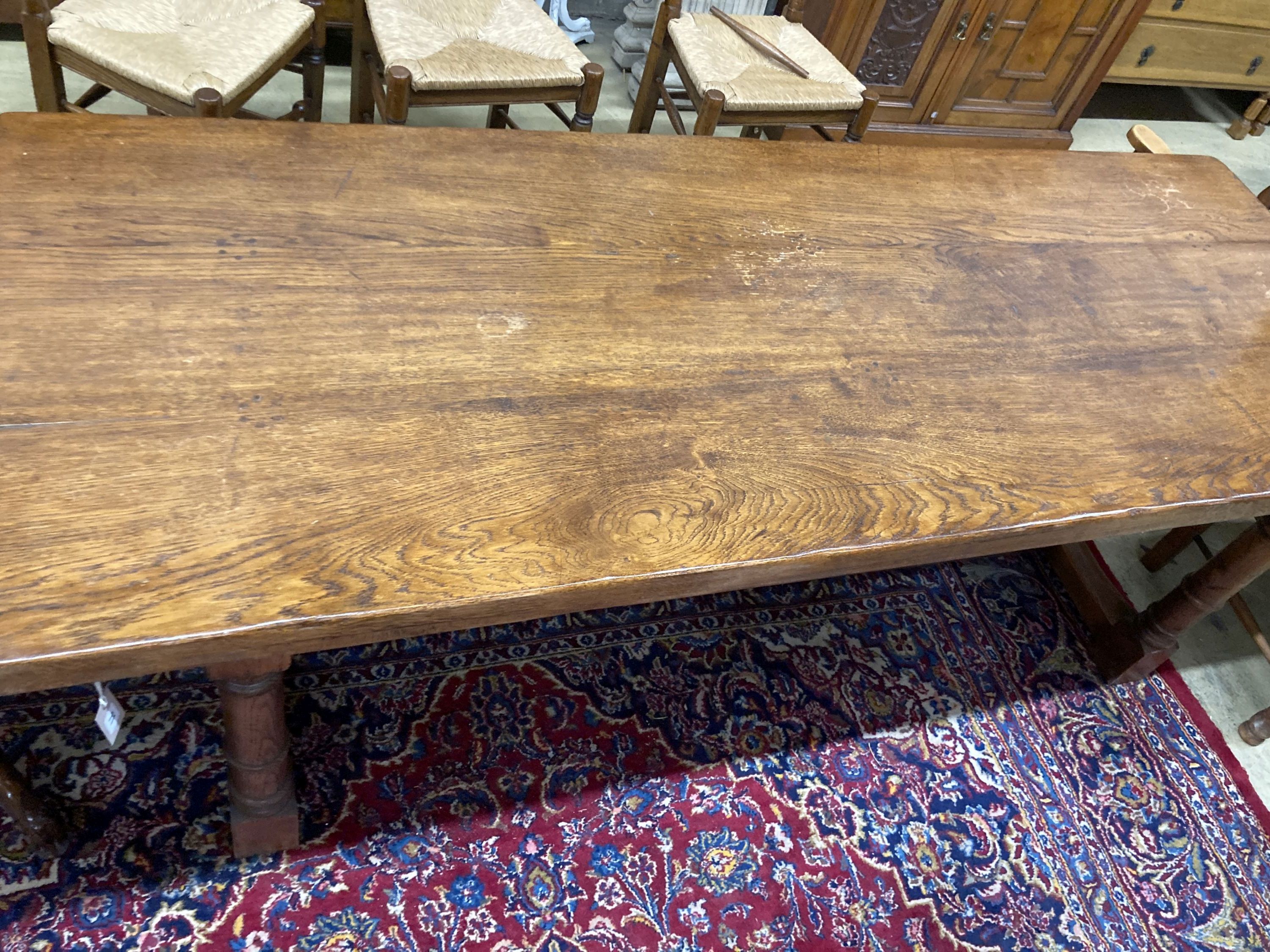 An 18th century style oak refectory dining table, length 214cm, depth 81cm, height 76cm